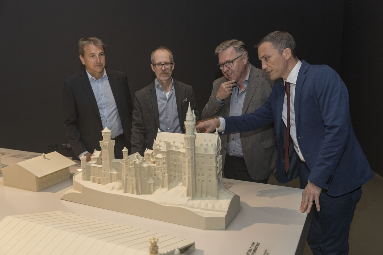 v.l.n.r.: Jörg Kaltmaier von der Firma Voxeljet, Architekturdesigner Robert Reiter, Dr. Rainhard Riepertinger und Dr. Andreas Kuhn (beide Haus der Bayerischen Geschichte) begutachten das 3D-Modell des Schlosses Neuschwanstein. 
